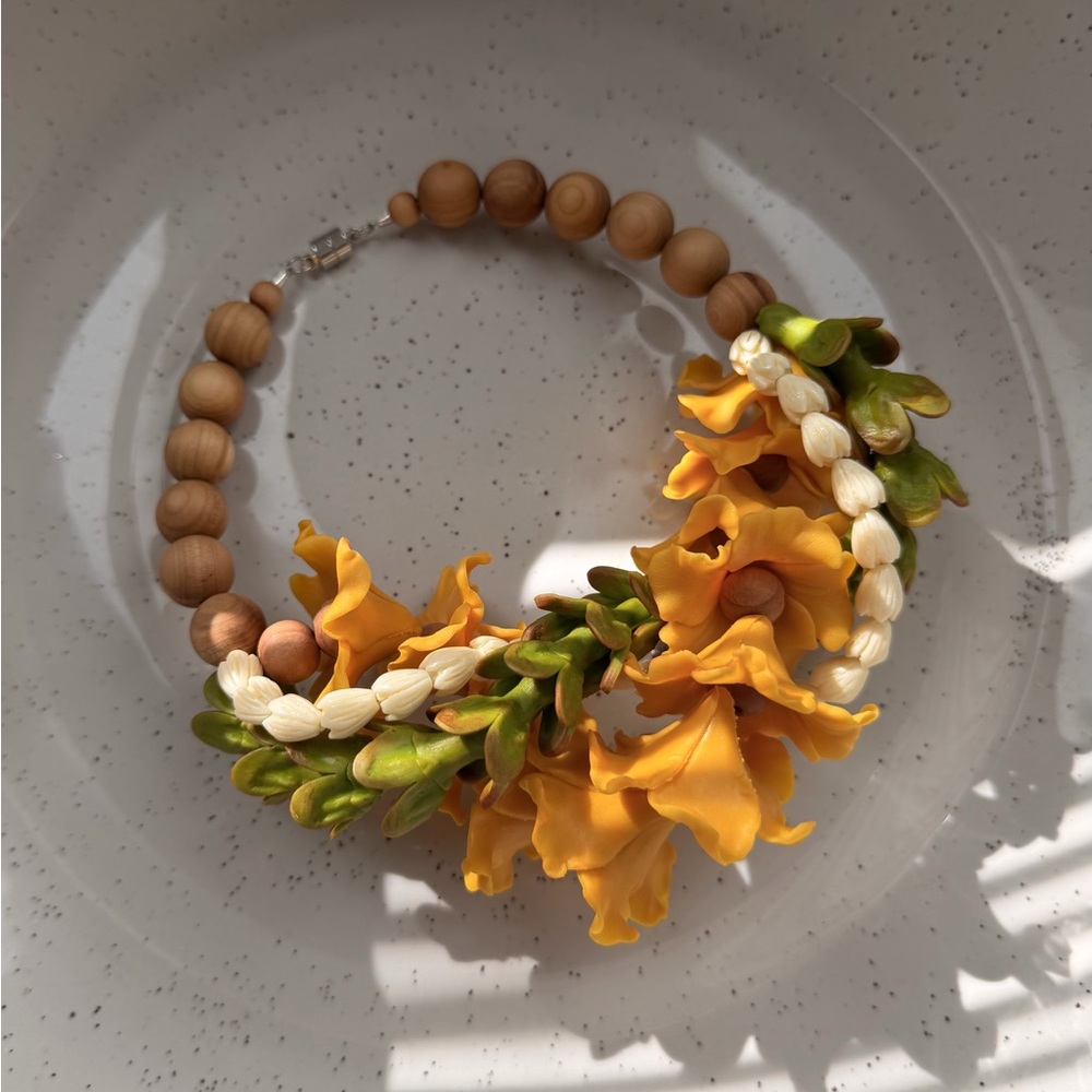 Burnt yellow hibiscus with pakalanas and pikake car lei